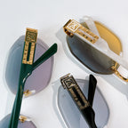 Sunglasses close-up showing green and gold-tone temples with decorative bar