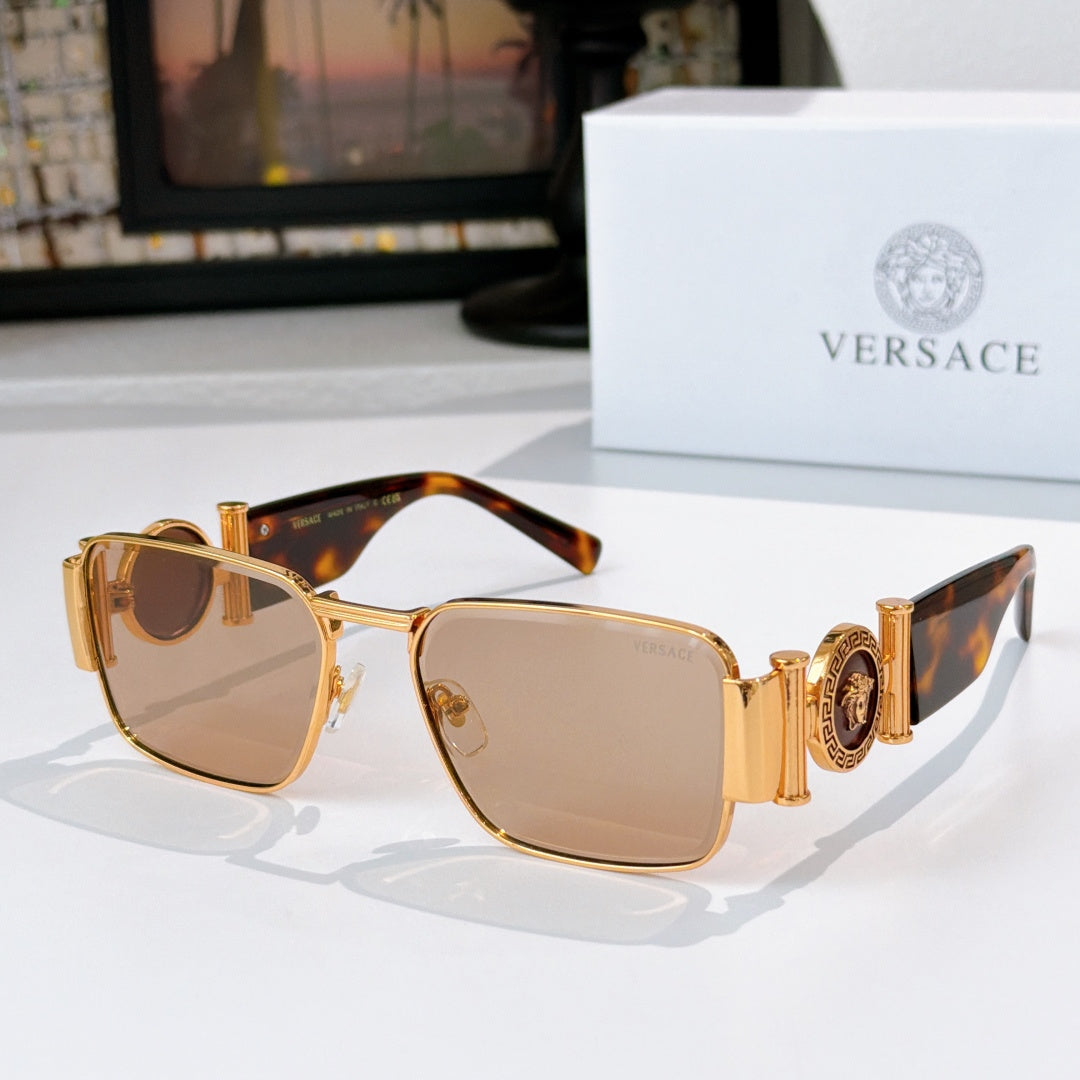 Versace sunglasses with gold frame, tortoise temples, and amber tinted lenses