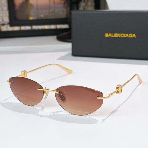 Balenciaga sunglasses with rose-brown tinted lenses and gold metal frames
