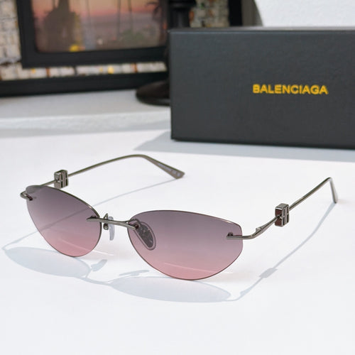 Balenciaga sunglasses with pink-tinted lenses and gold metal frames