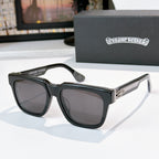 Dark-lens sunglasses with black frames and gold-engraved side lettering