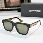 Olive-tinted sunglasses with black frames and gold side emblem detail