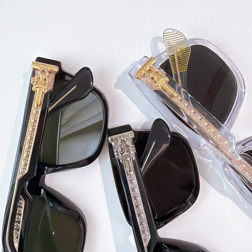 Sunglasses set in clear packaging with gold accents and dark lens frames