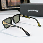 Black sunglasses side view with green lenses and gold accent temples