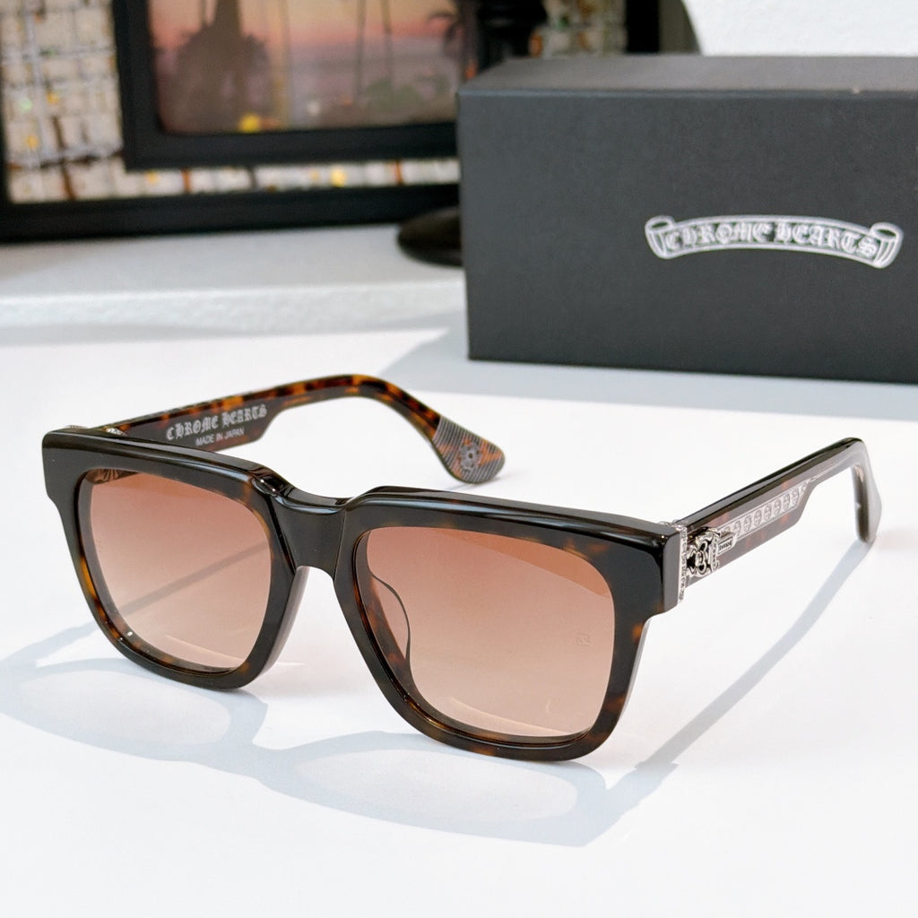 Amber-tinted sunglasses with tortoise frames and gold-engraved side lettering