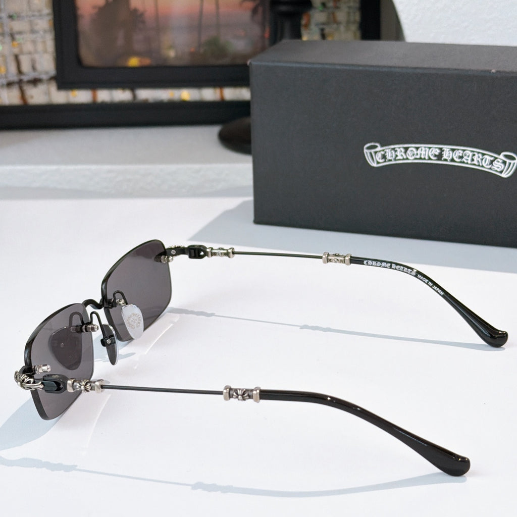 Sunglasses side view with dark lenses and black metal arms with embellishment