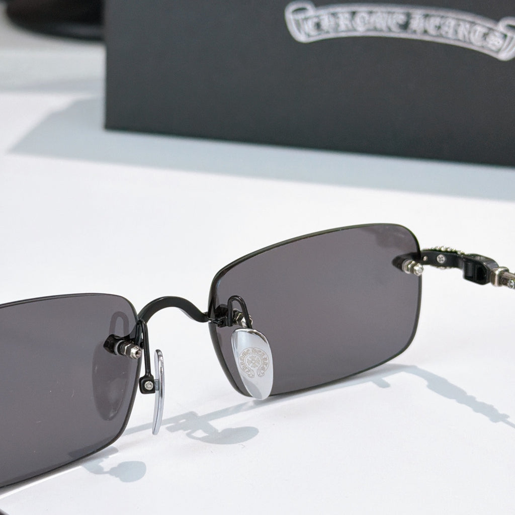 Sunglasses front close-up with dark lenses and black hinge detail