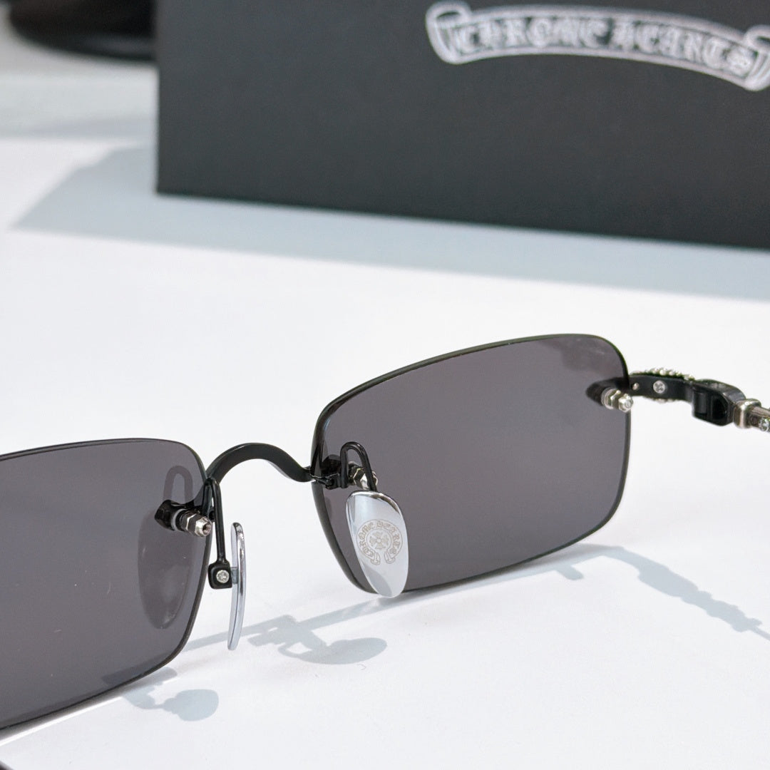 Sunglasses front close-up with dark lenses and black hinge detail