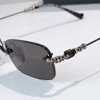 Sunglasses close-up with dark lenses and decorative metal temple detail