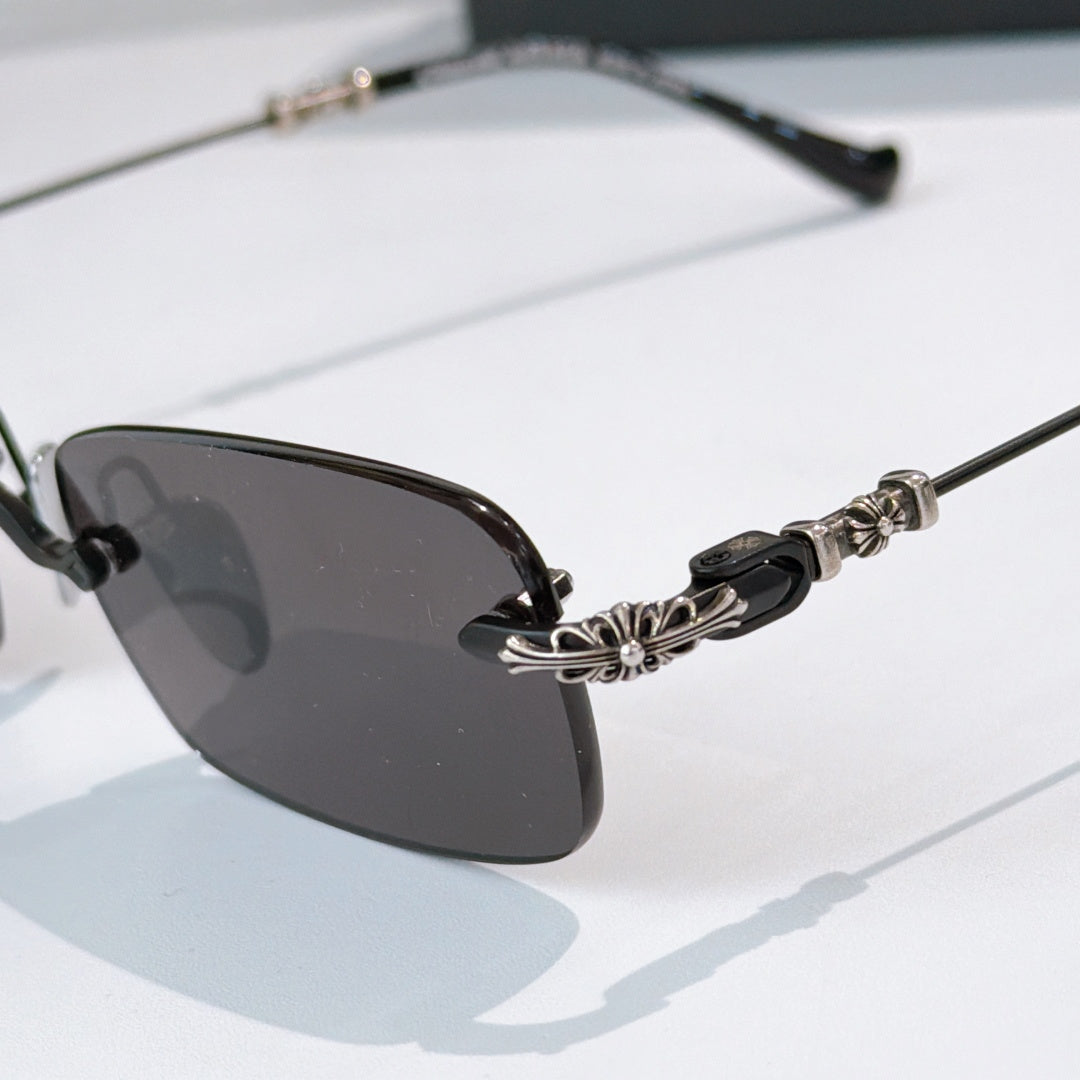 Sunglasses close-up with dark lenses and decorative metal temple detail