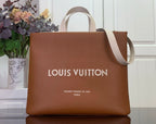 Louis Vuitton shopping bag in tan brown with top handles and printed logo