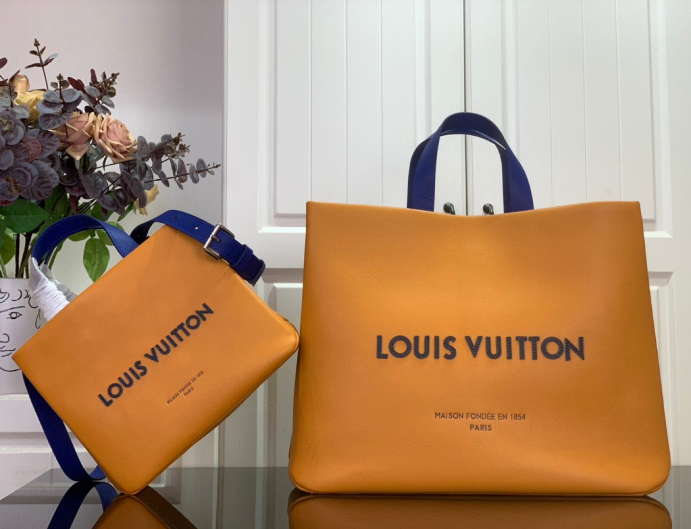 Louis Vuitton shopping bag set in orange with blue top handles and matching small pouch