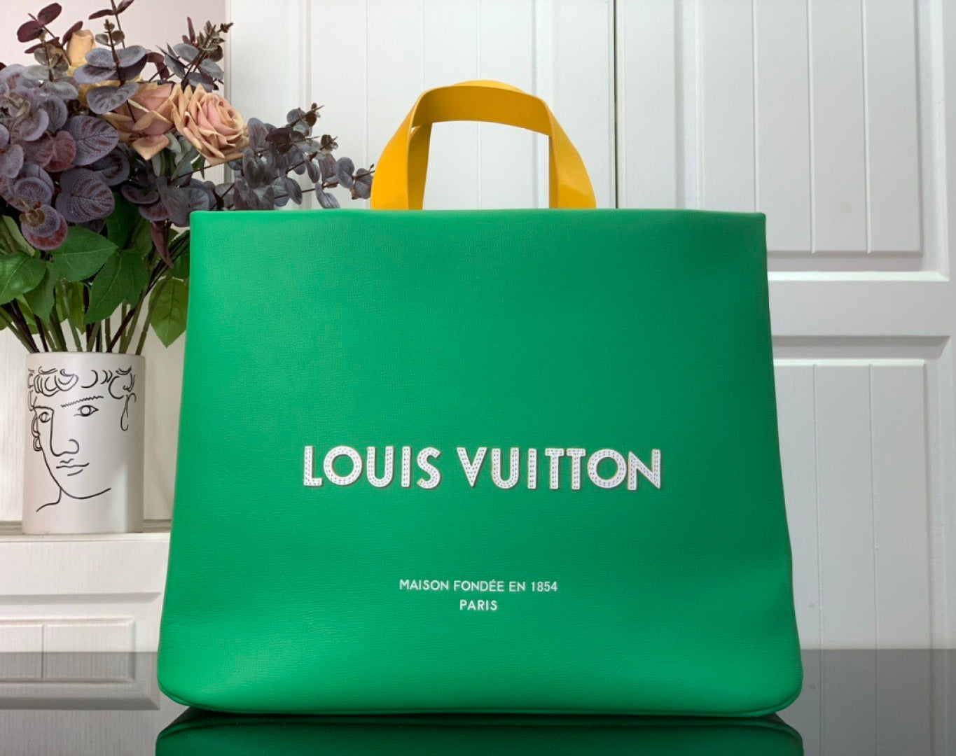 Louis Vuitton shopping bag in bright green with top handles and printed logo