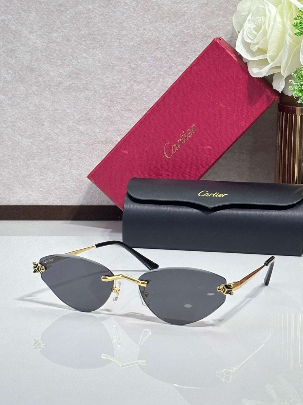 Gold-rim sunglasses with dark gray lenses and black temple tips