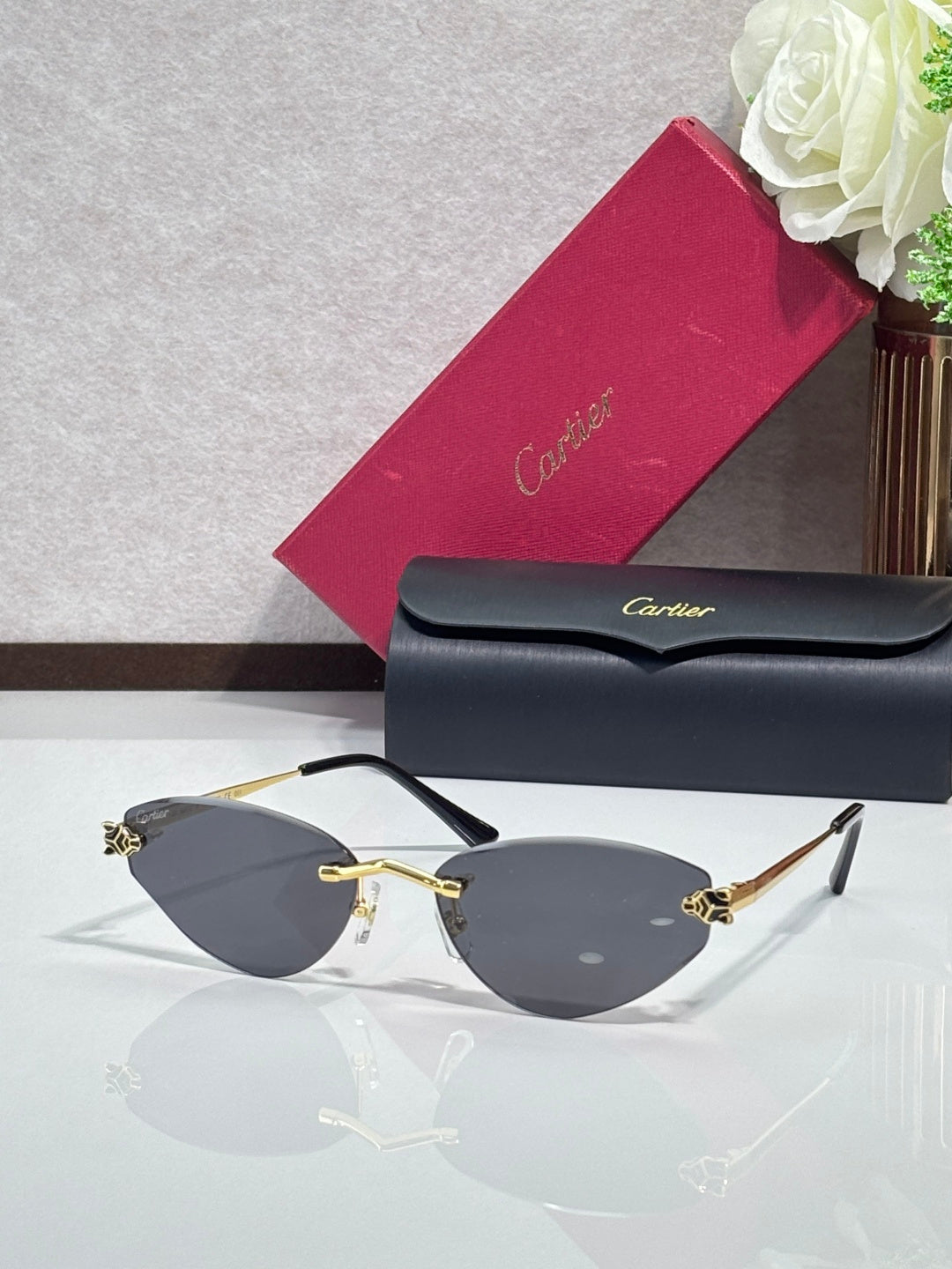 Gold-rim sunglasses with dark gray lenses and black temple tips
