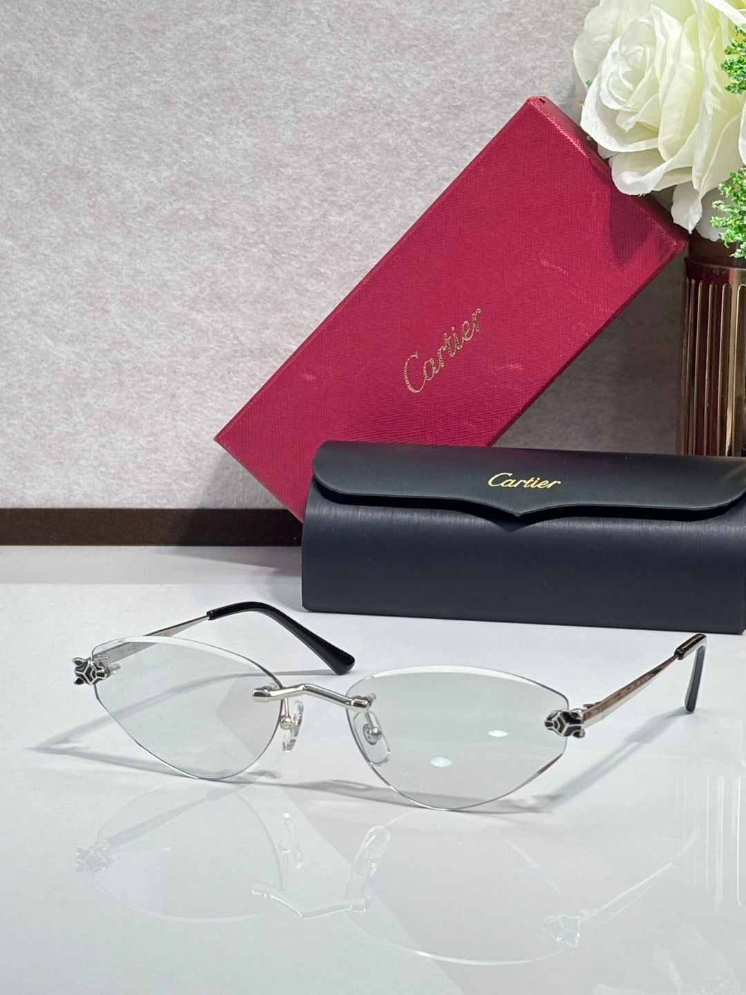 Gold-rim sunglasses with clear lenses and black temple tips