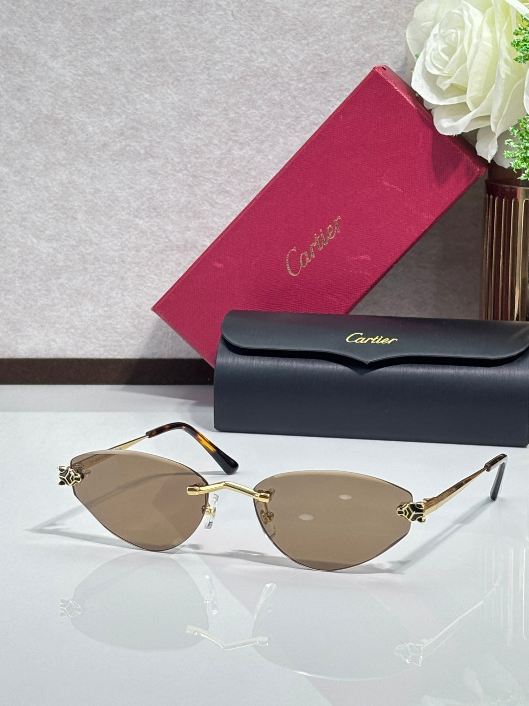Gold-rim sunglasses with tan lenses and black temple tips