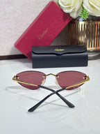 Gold-rim sunglasses with mauve pink lenses and black temple tips