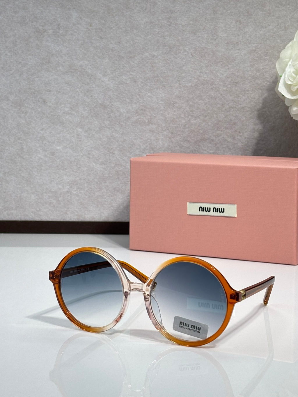 MiuMiu sunglasses with tortoiseshell round frames and blue tinted lenses, logo on lens