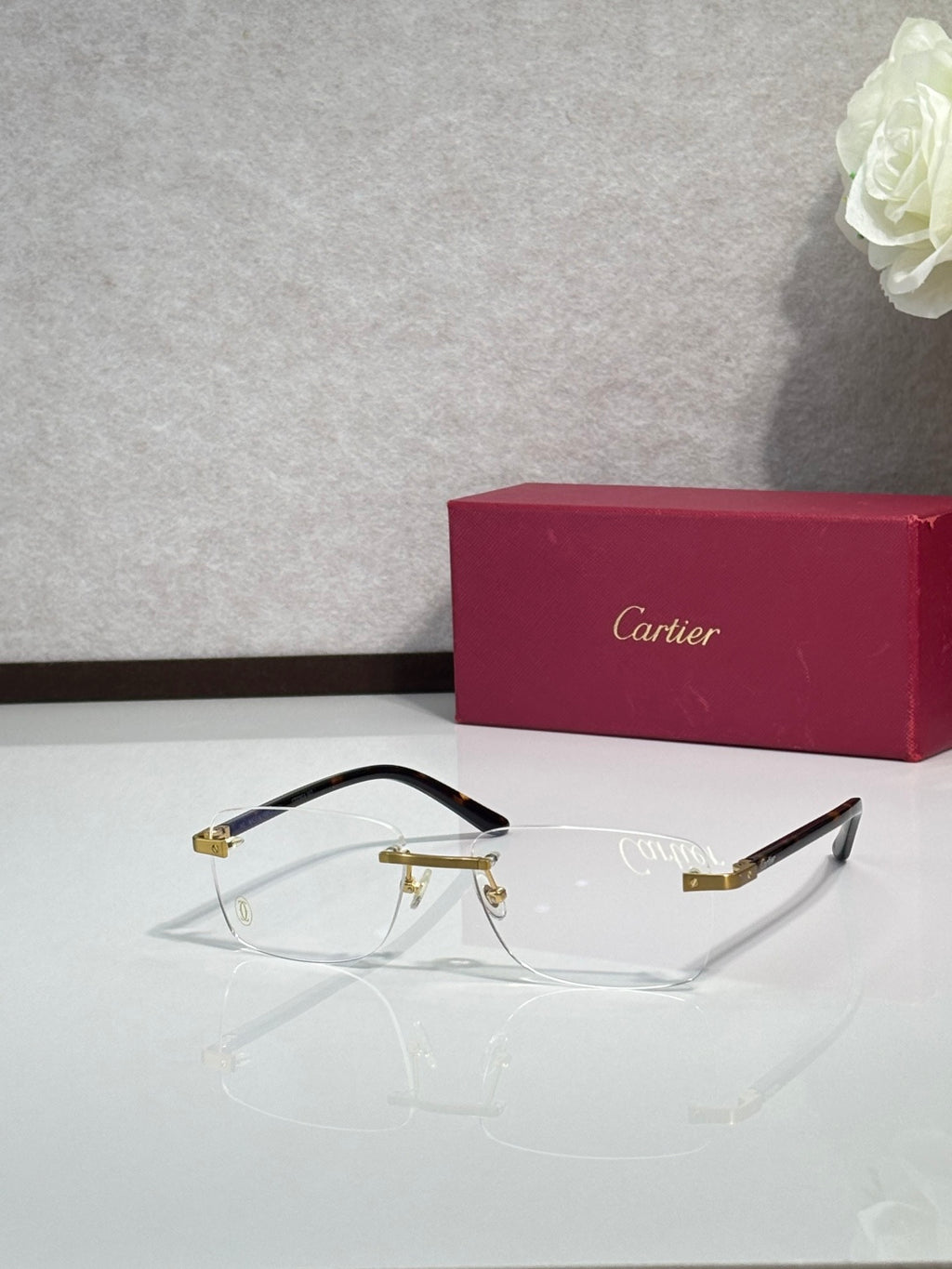 Cartier eyeglasses angled view with black frame and gold hinge details