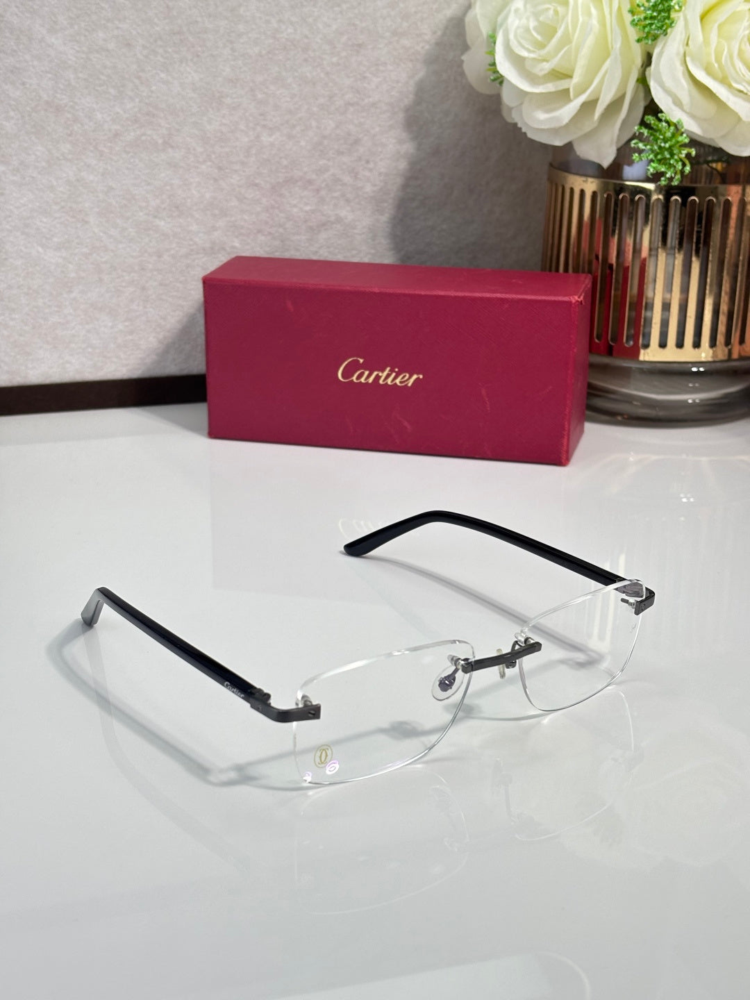Cartier eyeglasses with black frame, clear lenses, gold hinges