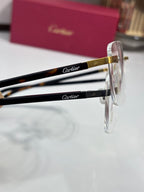 Cartier eyeglasses close-up of black temple with gold Cartier logo, clear lens