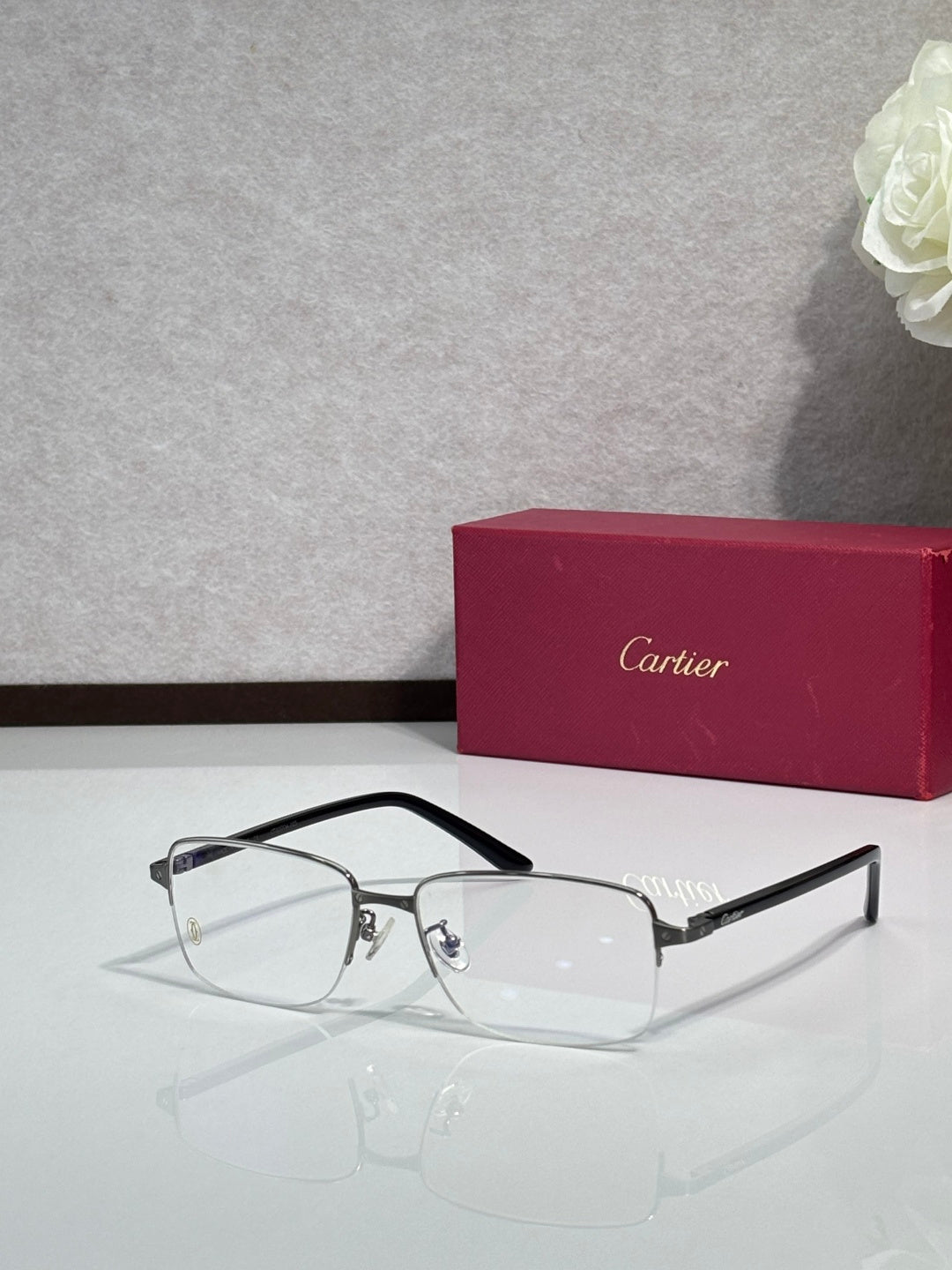 Cartier eyeglasses with black frame and clear lenses, thin metal arms