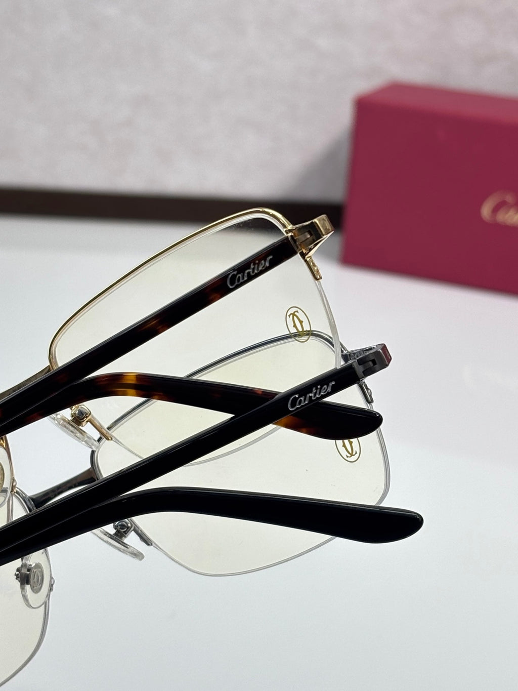 Cartier eyeglasses close-up with gold and black metal frames, clear lenses