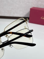 Cartier eyeglasses close-up with gold and black metal frames, clear lenses