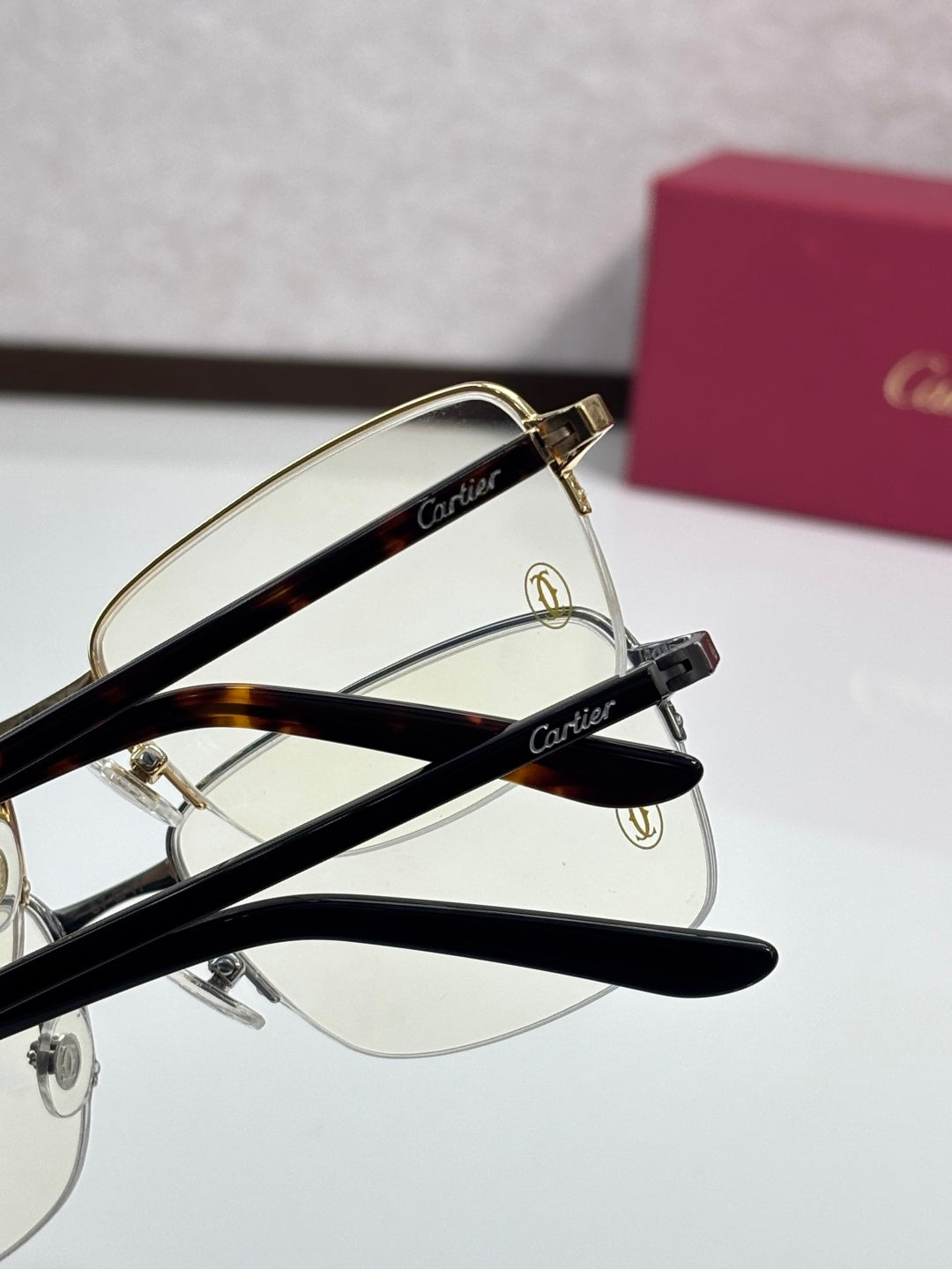 Cartier eyeglasses close-up with gold and black metal frames, clear lenses