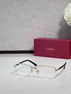 Cartier eyeglasses with gold metal frame, clear lenses, black side temples