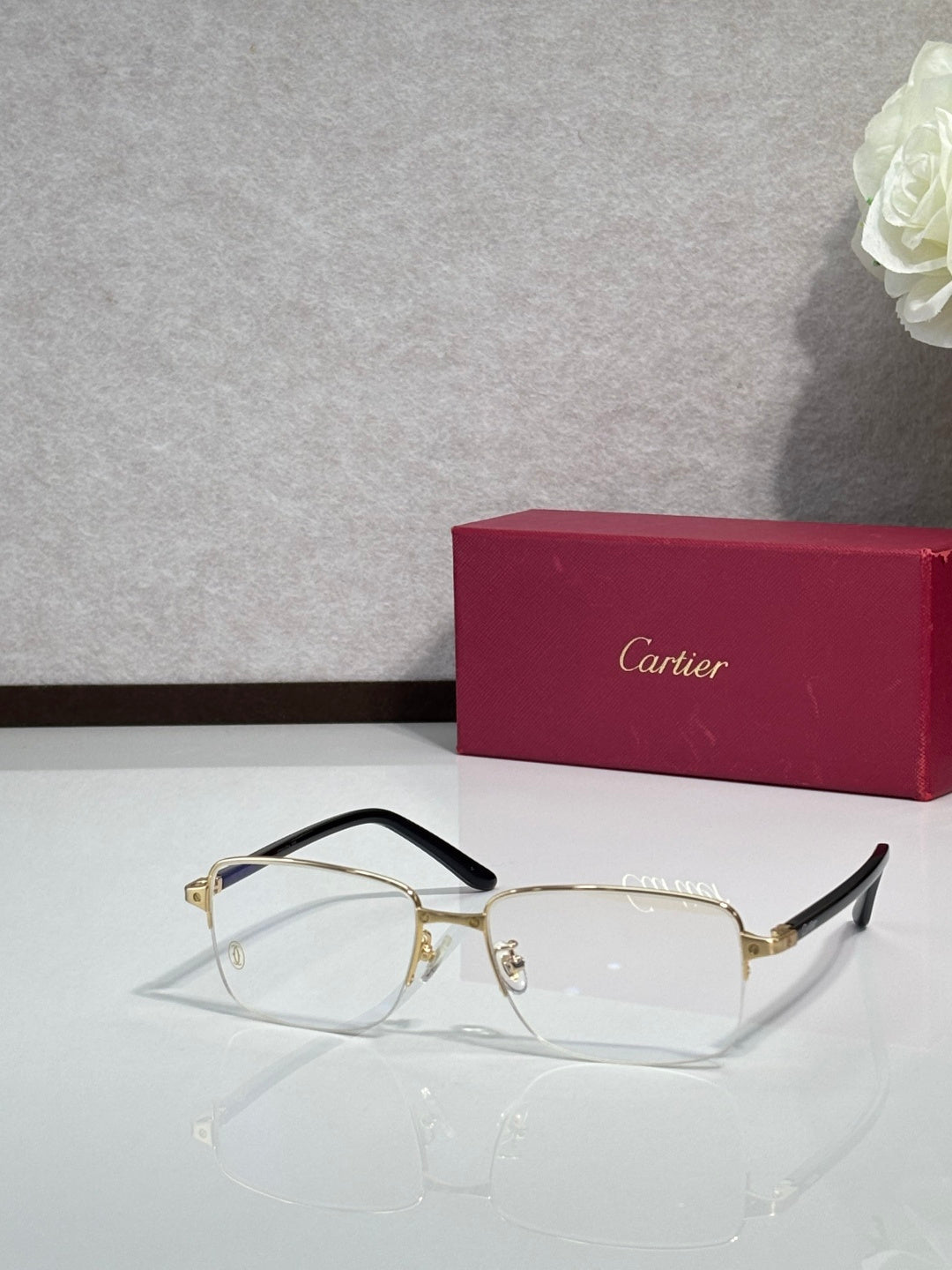Cartier eyeglasses with gold metal frame, clear lenses, black side temples