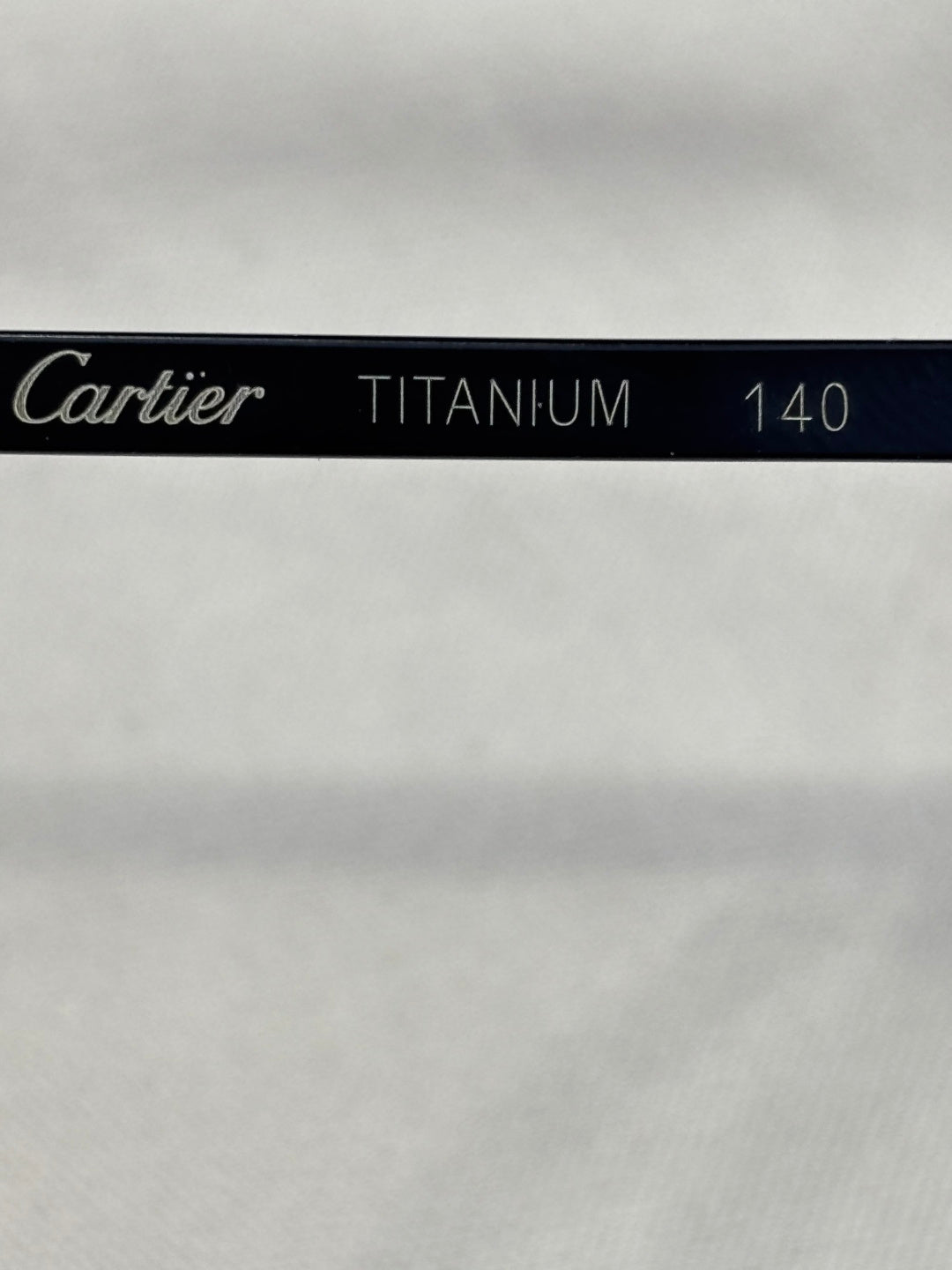 Cartier TITANIUM 140 engraving on black eyeglasses temple