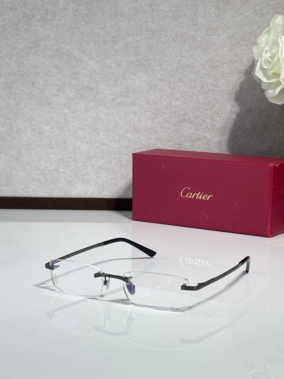 Cartier eyeglasses with black rectangular frame and clear lenses, slight purple detail