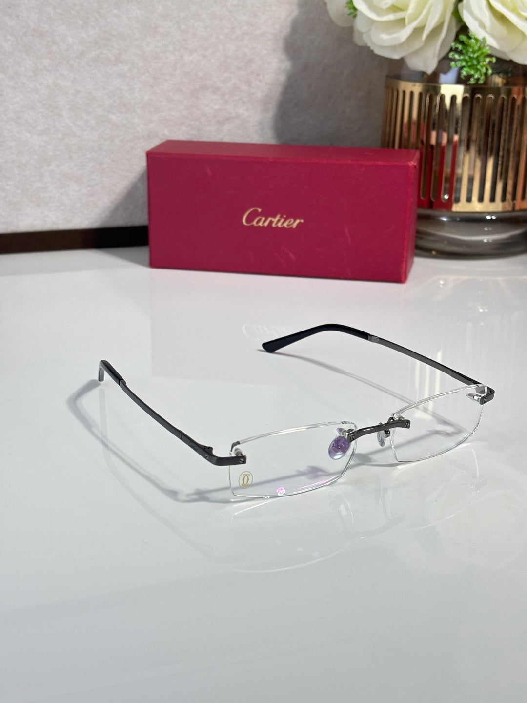 Cartier eyeglasses with black frame and clear lenses with subtle purple tint