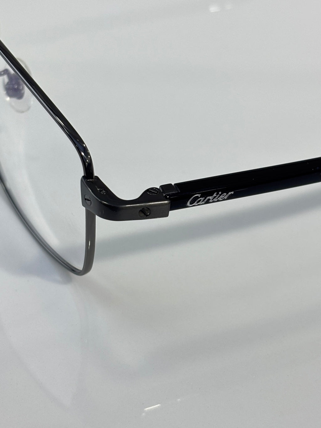 Black eyeglasses hinge with Cartier logo on temple arm