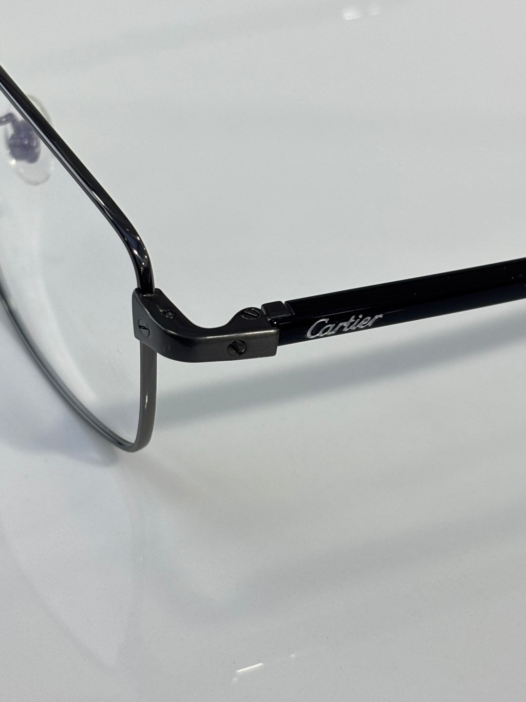 Black eyeglasses hinge with Cartier logo on temple arm