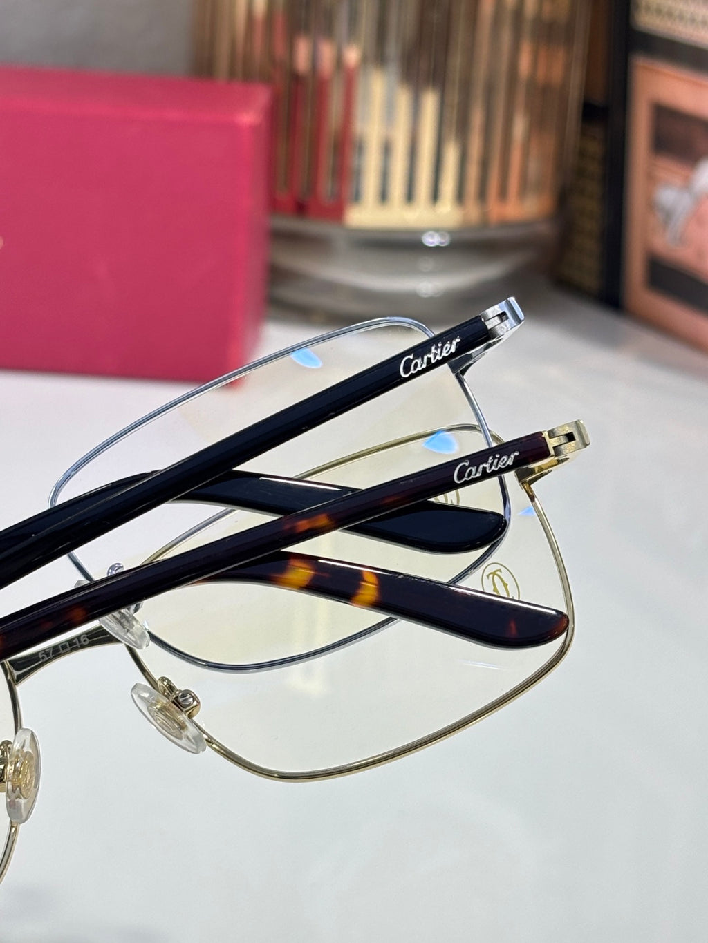 Blue-and-gold eyeglasses temples with Cartier logo