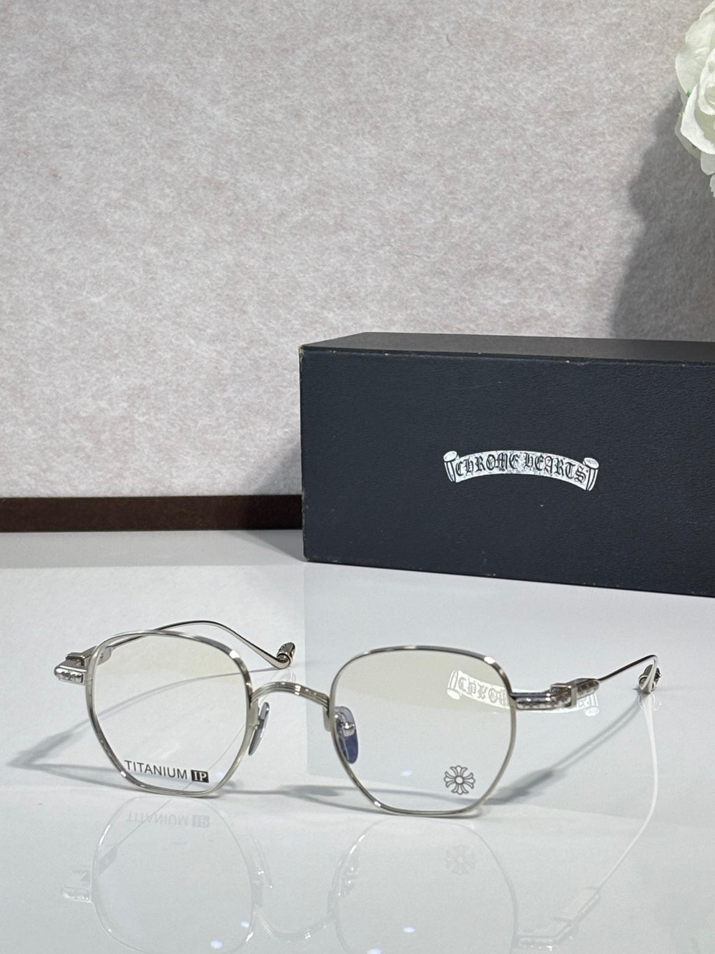 Silver round eyeglasses with clear lenses and metal arms with hinges.