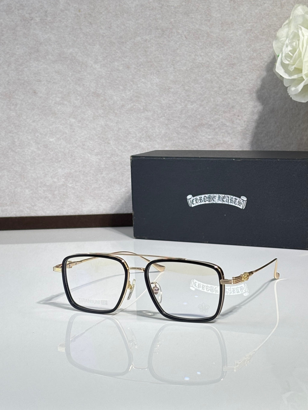 Gold-toned rectangular eyeglasses with clear lenses and thin metal arms.