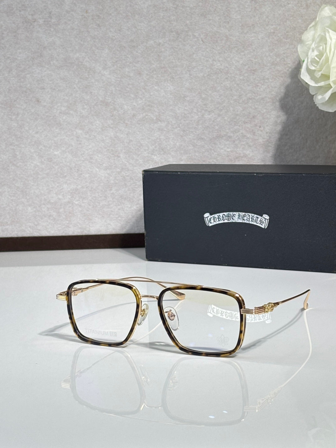 Gold rectangular eyeglasses with clear lenses and slim gold-toned temples.
