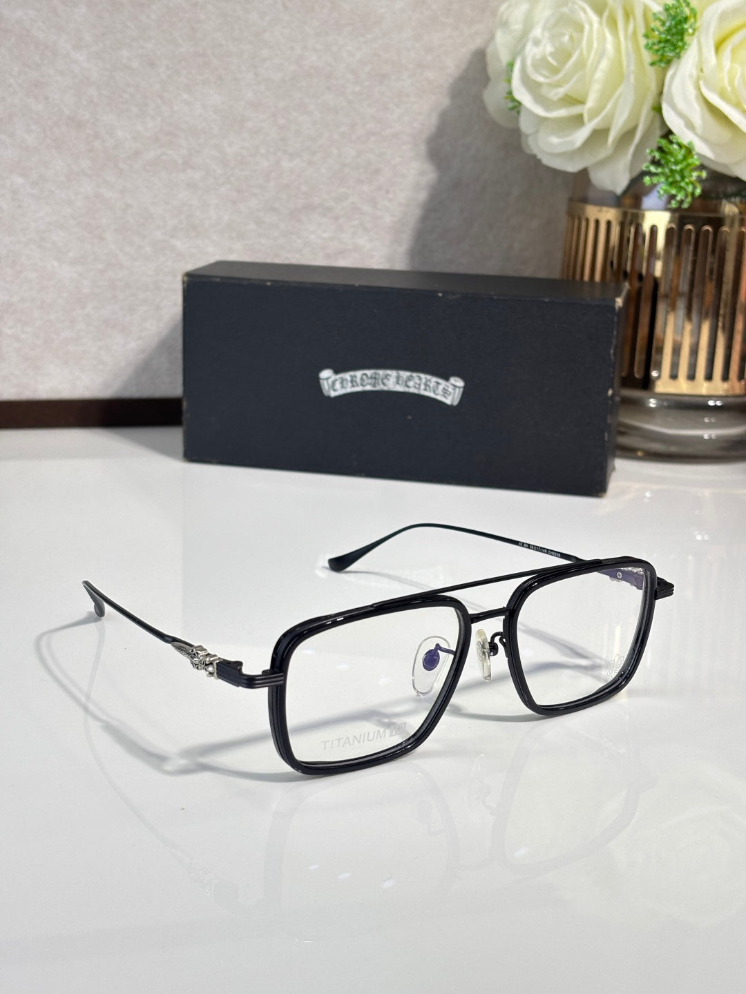 Black rectangular eyeglasses angled view with clear lenses and metal hinges.