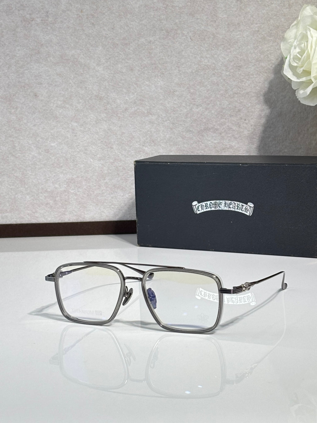 Black rectangular eyeglasses with silver-toned hinges and clear lenses.