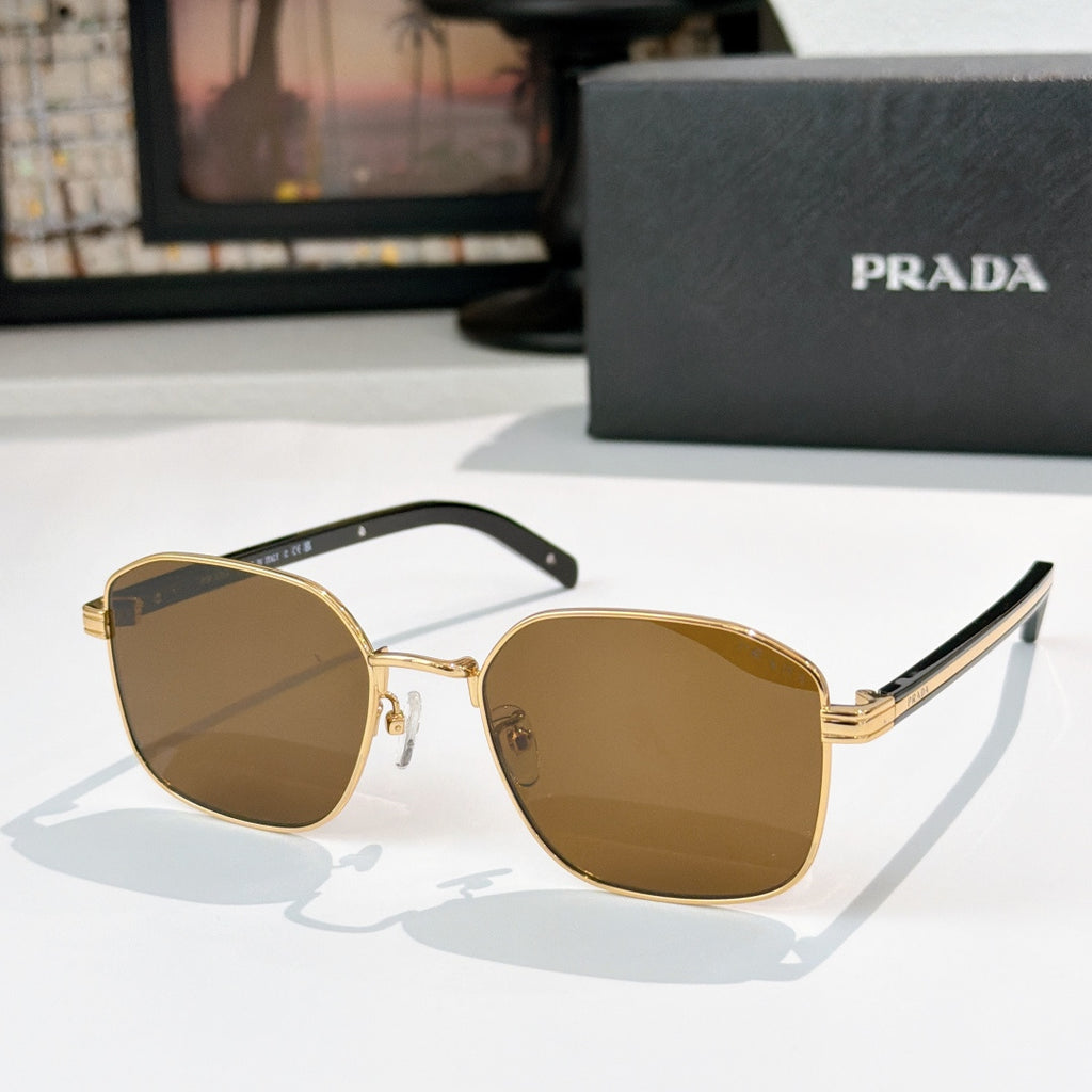 Sunglasses with brown tinted lenses, gold frame, and black inner temple sections.