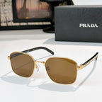 Sunglasses with brown tinted lenses, gold frame, and black inner temple sections.