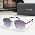 Sunglasses with dark purple tinted lenses, black frame, and gold temple accents.