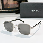 Sunglasses with gray tinted lenses and silver frame, with black temple details.