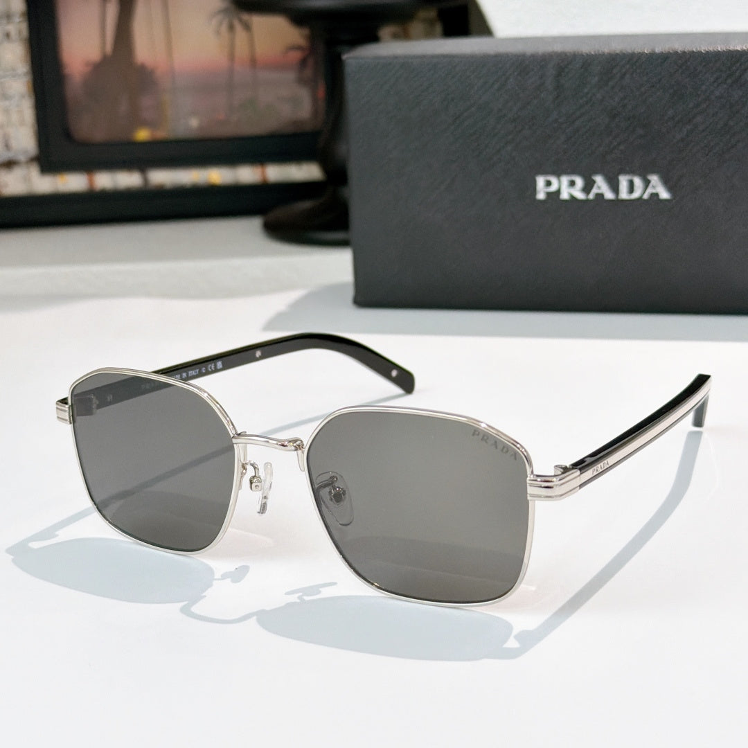 Sunglasses with gray tinted lenses and silver frame, with black temple details.