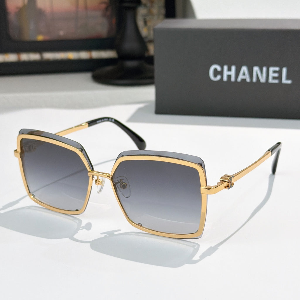 Square sunglasses with gold frame and dark gray lenses
