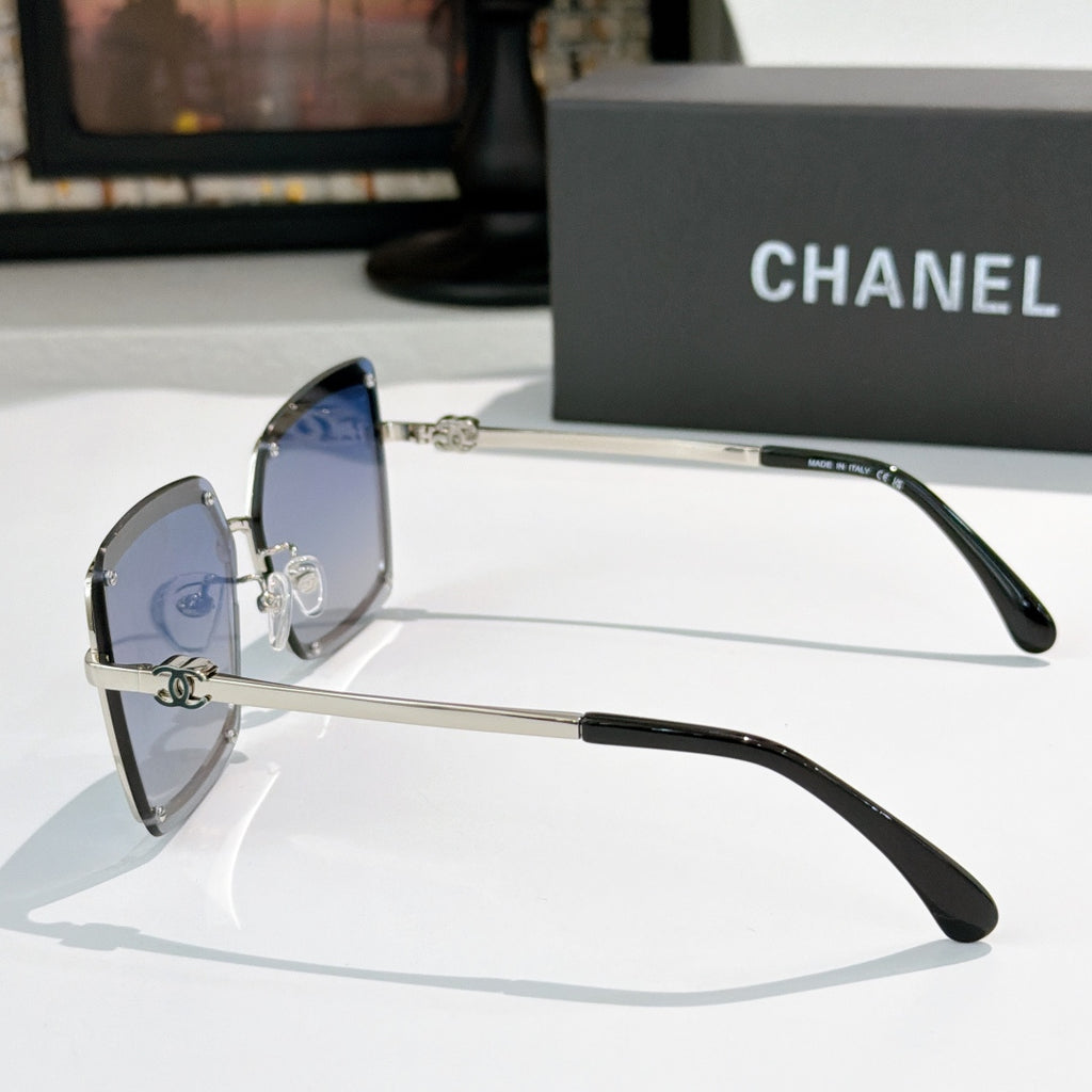 Square sunglasses with silver frame, blue lenses, and black temples
